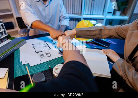 Engineers and architects analyze construction models and discuss project strategies, combining technical knowledge and creative ideas to achieve succe Stock Photo