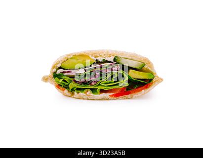 Fresh sandwich with greens, cucumbers, and vibrant vegetables on display Stock Photo