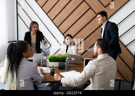 A group of businessmen of different nationalities during a brainstorming meeting in a stylish office Stock Photo