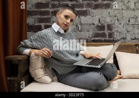 Elegant businesswoman working in the company behind a laptop Stock Photo
