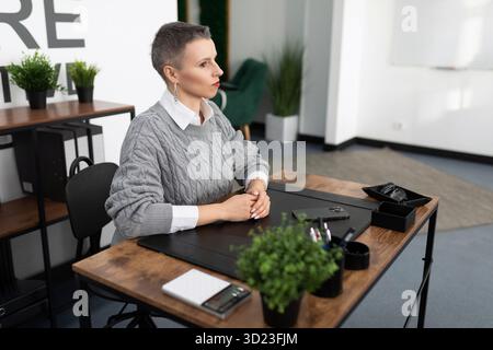 Woman worker in the office sitting at the table Stock Photo