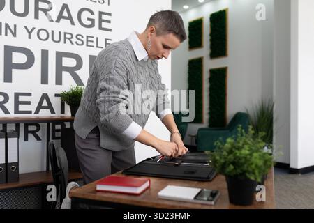 Mature woman with a short haircut in the office working with documents Stock Photo