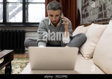 Businesswoman working on startup project sitting with laptop Stock Photo