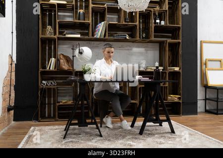 Businesswoman working on startup project sitting with laptop Stock Photo