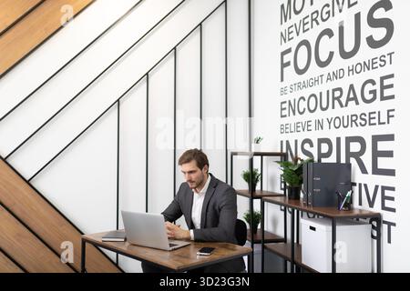 Successful businessman in business clothes working on a laptop in the office Stock Photo