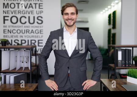 Portrait of a successful manager in a business suit in the middle of the office Stock Photo