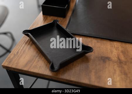Accessory for stationery made of genuine leather on a working wooden table in the office Stock Photo