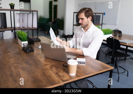 Male businessman working with documents laptop in the office Stock Photo