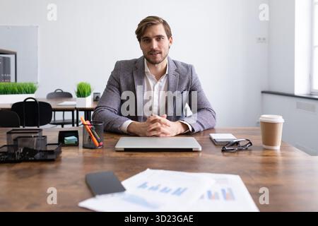 Successful business man conducts an interview while sitting at a table in the office Stock Photo
