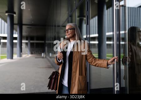Elderly businessmen enters the office building Stock Photo