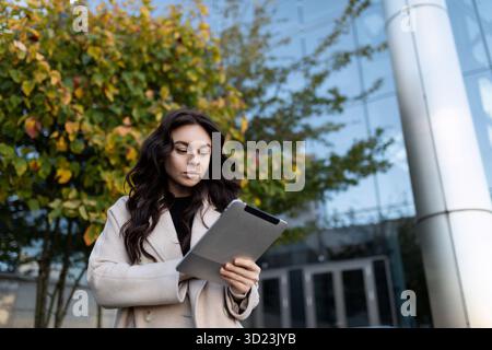 Highly successful businessman work remotely with tablet outside Stock Photo