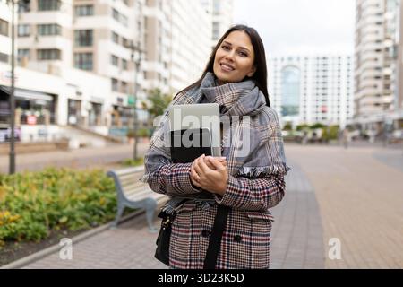 Portrait of a successful middle-aged woman businessman against the backdrop of urban development Stock Photo