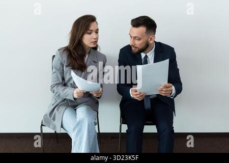 Exciting waiting for an interview of a man and a woman when applying for a job Stock Photo
