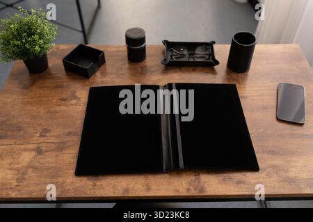 Workplace in the office with a leather folder for papers on the table Stock Photo