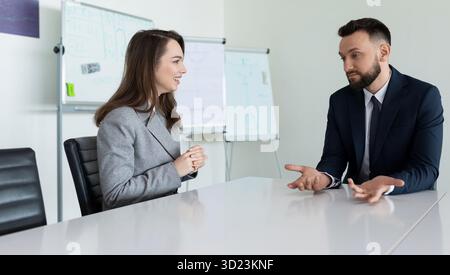 Discussion of a new project in the office at the table in the meeting room Stock Photo