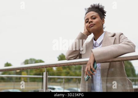 Portrait of a serious pensive black young woman looking longingly into the distance Stock Photo