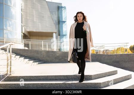 Businesswoman in stylish clothes on the background of an office building Stock Photo