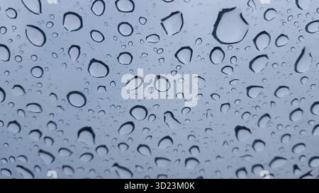 Rain water texture on glass panel with blue grey background abstract pattern Stock Photo