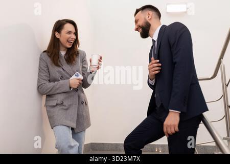 Informal communication between a man and a woman during a lunch break in the office Stock Photo
