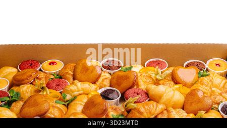 Assorted pastries displayed in a box for a dessert event Stock Photo