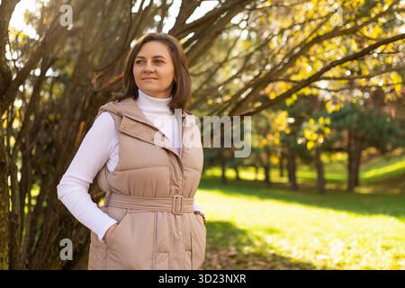 Young woman in autumn casual clothes walks in the autumn park Stock Photo