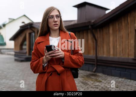 Business young caucasian woman with a smartphone in her hands Stock Photo