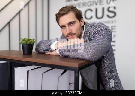 Thoughtful businessman in a jacket in the office Stock Photo