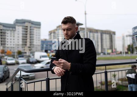 Young man waiting for a meeting looking at his watch in the office Stock Photo