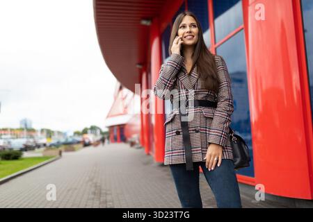 Beautiful woman talking on the phone outside Stock Photo