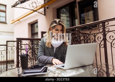 Business woman working on laptop outside Stock Photo