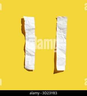 Two crumpled white paper strips on bright yellow background with shadows Stock Photo