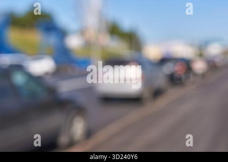 Motion blur of cars on a busy urban street on a clear day with blue skies Stock Photo