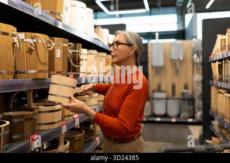 Shopping for decorative wooden storage baskets in a home goods store during the afternoon Stock Photo