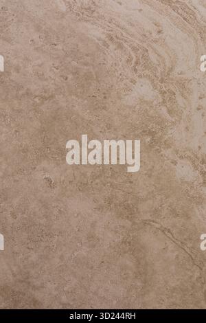 Surface texture of natural stone showing intricate patterns and earthy colors in a warm, subtle lighting environment Stock Photo