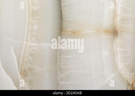 Natural onyx stone surface with intricate patterns and soft colors showcasing unique texture and beauty Stock Photo
