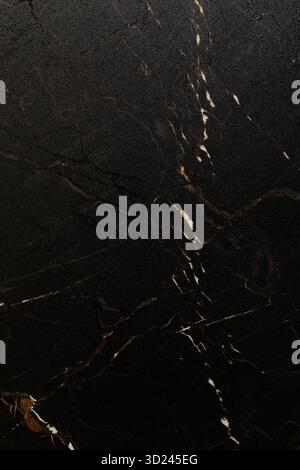 Rich black marble surface with white veins displaying elegant natural patterns and textures suitable for various design applicat Stock Photo