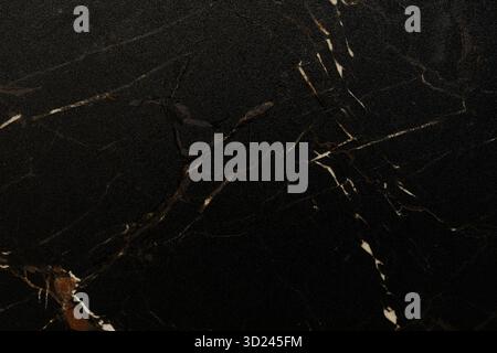 Black marble surface with elegant white and brown veins showcasing natural beauty in a modern design context Stock Photo