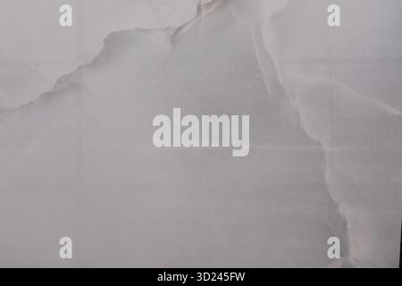 Torn white paper with soft texture and subtle shadows on a light background creating an abstract visual effect Stock Photo