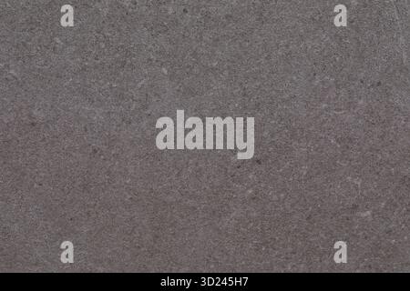 Textured gray surface with subtle variations and natural patterns seen in a close-up view during daylight Stock Photo