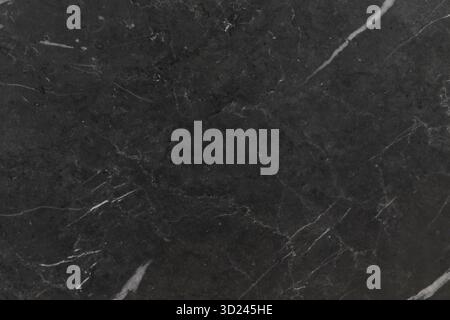 Dark marble surface with white veins showcasing a sleek, elegant texture for modern design projects Stock Photo