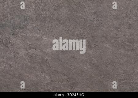 Surface of textured stone showing fine details and natural variations in color and pattern in a close-up view Stock Photo