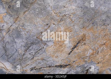 Stunning abstract texture of gray and gold stone surface in natural light Stock Photo
