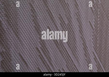 Close-up view of textured wall surface displaying unique patterns and color variations in natural light Stock Photo