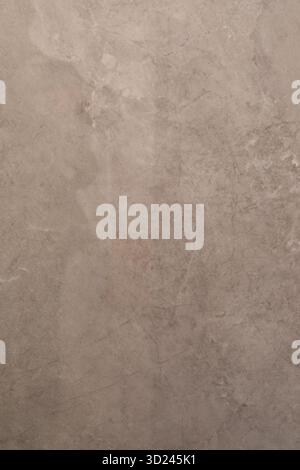 Textured wall surface displaying natural patterns and subtle color variations in a minimalist setting Stock Photo