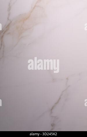Close-up view of smooth marble surface showcasing unique veining patterns in soft shades of cream and beige Stock Photo