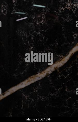 Dark marble surface with contrasting light veins and textured patterns for elegant interior design inspirations Stock Photo