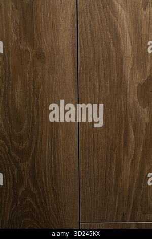 Wooden texture background featuring rich grain patterns in dark brown shades from a close-up view Stock Photo