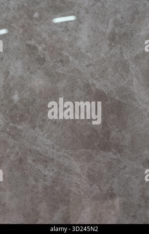 Marble texture with subtle patterns highlighting shades of gray and purple in a natural stone surface Stock Photo