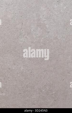 Close-up view of light gray concrete texture showing subtle variations in color and pattern during daylight Stock Photo