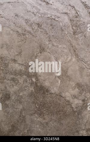 Abstract patterns on natural stone surface showcasing textured beige and gray tones with subtle marbling details Stock Photo